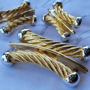 Vintage brooch and clip earring set gold w silver accents.